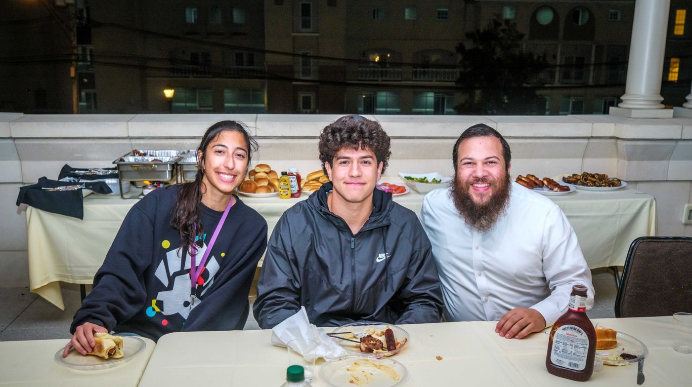 Rabbi Greenberg and students enjoying a meal together